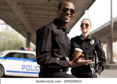 happy young police officers having coffee break