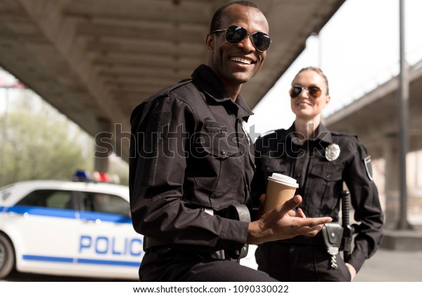 happy young\
police officers having coffee\
break