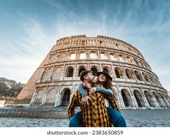 Happy young romantic couple having fun together in Rome Colosseum - Love relationship and travel lifestyle concept