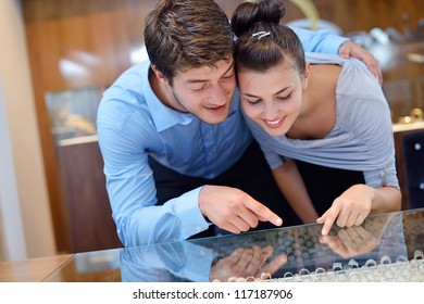 Happy Young Romantic Couple In Love Buy Jewelry Ring In Luxury Store