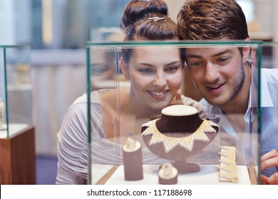 Happy Young Romantic Couple In Love Buy Jewelry Ring In Luxury Store