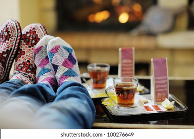 happy Young romantic couple and relaxing sofa in front of fireplace at winter season in home - Powered by Shutterstock