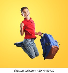 Happy Young School Child With Backpack Jumping