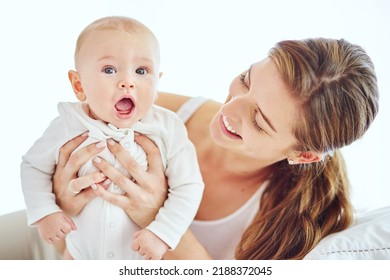 Happy, Young And Single Mother Bonding And Taking Care Of Adorable Baby, Enjoying Parenthood And Being A New Mom. Happy Female Experiencing Maternal Instinct, Holding Cute, Little Child On A Bed.