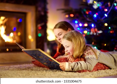 happy-young-sisters-reading-story-260nw-