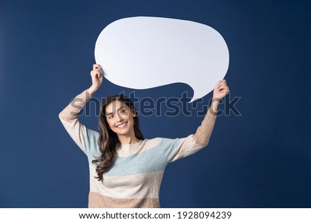 Happy young smiling Asian woman holding copy space empty message bubbles on blue color background, thinking and specking via balloon blank paper, Private opinion for advertisement Concept