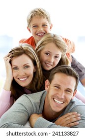 Happy Young Standard Caucasian Family Making A Human Pyramid