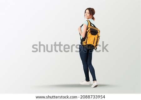 Happy young student posing with a backpack