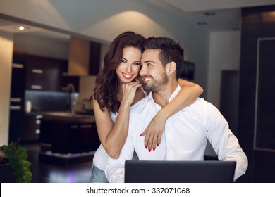 Happy Young Successful Manager Couple At Home With Laptop, Confident People