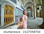 Happy young tourist woman visit ancient Istanbul Topkapi palace. Follow me to Istanbul, Turkey