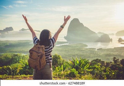 Happy Young Traveler Woman Backpacker Raised Arm Up To Sky Enjoying A Beautiful Of Nature At Top Of Mountain And Sea View,Freedom Wanderlust Concept