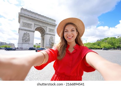 Happy young traveler woman taking selfie photo with Arc de Triomphe in Paris, France - Powered by Shutterstock