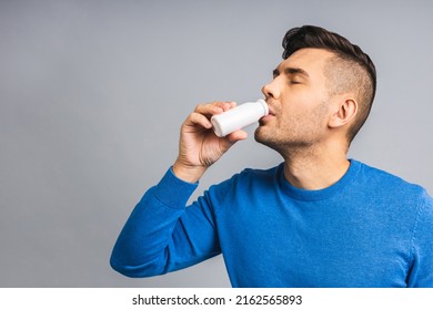 Happy Young Ukrainian Handsome Man Drinking Probiotic Yogurt Isolated Over Grey White Background. Healthy Lifestyle Concept.