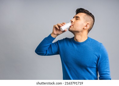 Happy Young Ukrainian Handsome Man Drinking Probiotic Yogurt Isolated Over Grey White Background. Healthy Lifestyle Concept.