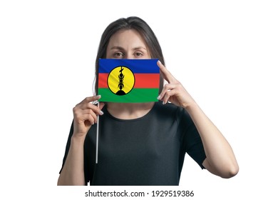 Happy Young White Woman Holding Flag New Caledonia Flag And Covers Her Face With It Isolated On A White Background.