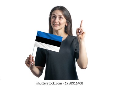 Happy Young White Woman Holding Flag Of Estonia And Points Thumbs Up Isolated On A White Background.