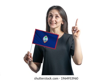 Happy Young White Woman Holding Flag Of Guam And Points Thumbs Up Isolated On A White Background.