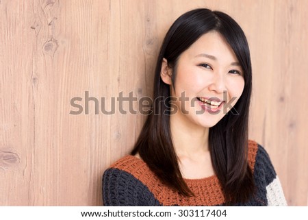 happy young woman against wooden wall