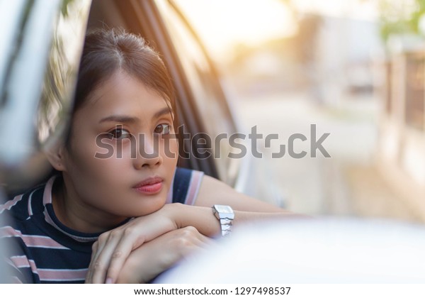Happy young woman in\
the car, Closeup portrait happy smiling young attractive woman\
buyer sitting in her new car. Personal transportation auto purchase\
concept