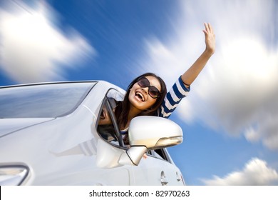 Happy Young Woman In Car Driving On The Road