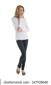 Happy young woman in casuals looking away while standing isolated over white background
