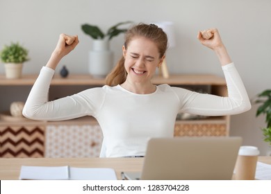 Happy Young Woman Celebrating Online Win At Home, Excited Millennial Student Rejoicing Receiving Good Test Exam Results Or College Admission Letter On Laptop, Winner Satisfied With Success Victory