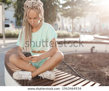 Happy young woman chating with phone