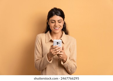 happy young woman checking smartphone  in beige colors. app, social media, addiction, network concept. - Powered by Shutterstock