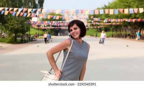 Happy Young Woman City Holiday. Standing In A Busy City Square.