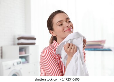 Happy Young Woman With Clean Shirt Indoors. Laundry Day