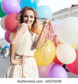 Happy Young Woman With Colorful Latex Balloons, Outdoors