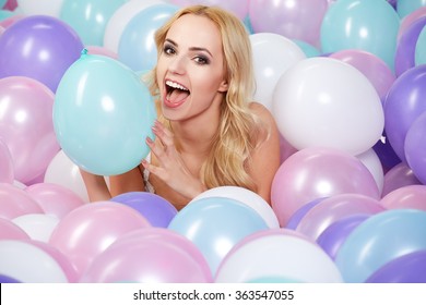 Happy Young Woman With Colorful Latex Balloons