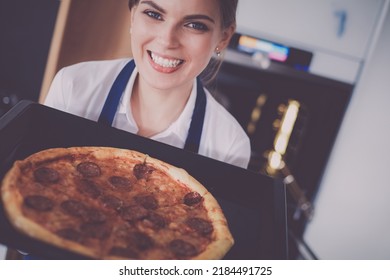 Happy Young Woman Cooking Pizza At Home