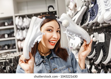 Happy Young Woman Customer Choosing Pair Of Sneakers Shoes And Buying It In Clothes Store, Casual Shopping Concept