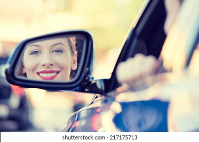 Happy Young Woman Driver Looking In Car Side View Mirror, Making Sure Line Is Free Before Making A Turn. Human Facial Expressions, Emotions. Safe Trip, Journey Driving Concept