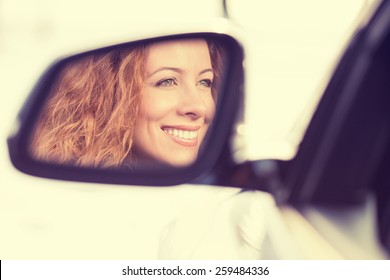 Happy Young Woman Driver Reflection In Car Side View Mirror. Positive Human Face Expressions, Emotions. Safe Winter Trip, Journey Driving Concept