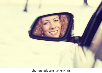 Happy Young Woman Driver Reflection In Car Side View Mirror. Positive Human Face Expressions, Emotions. Safe Winter Trip, Journey Driving Concept