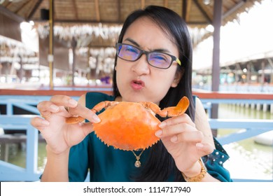 Happy Young Woman Eating Big Steamed Crab