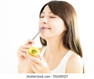 Happy Young Woman Eating Kiwi Fruit