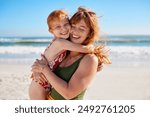 Happy young woman embracing her daughter at beach with copy space while laughing together. Cute little girl with freckles playing with mom outdoor at seaside. Close up of carefree mom hugging child.