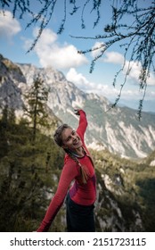Happy young woman is enjoying her hike on a sunny September hike in Julian Alps.
