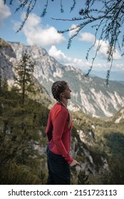 Happy young woman enjoying view point in Julian Alps during her hike on a sunny September afternoon.