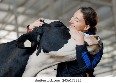 Happy young woman farm worker hugging cow as sign of concern for animal health care. Concept agriculture cattle livestock farming industry. - Powered by Shutterstock