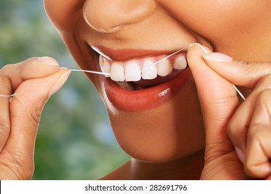 Happy Young Woman Flossing Teeth.