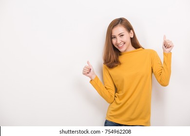 Happy young woman giving thumbs up on white background