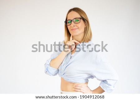 Happy young woman with glasses thinking over white background.