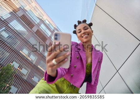 Similar – Image, Stock Photo Young woman vlogging outdoors with a mobile gimbal