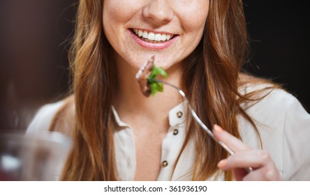 Happy Young Woman Having Dinner At Restaurant