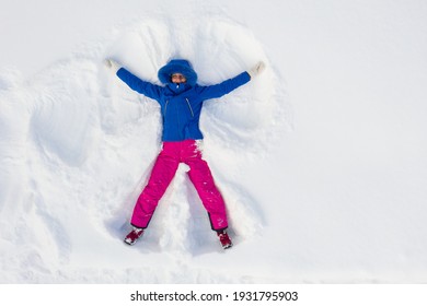 Happy Young Woman Having Fun And Making Snow Angel, Top View. 