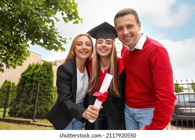 Happy Young Woman With Her Parents On Graduation Day